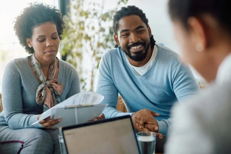 A couple reviewing mortgage paperwork with their advisor