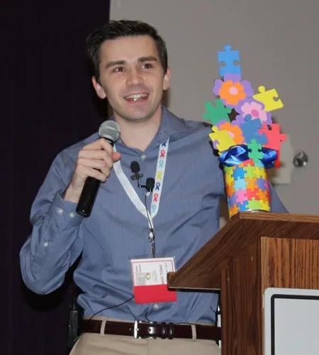 Tyler McNamer speaking at a podium